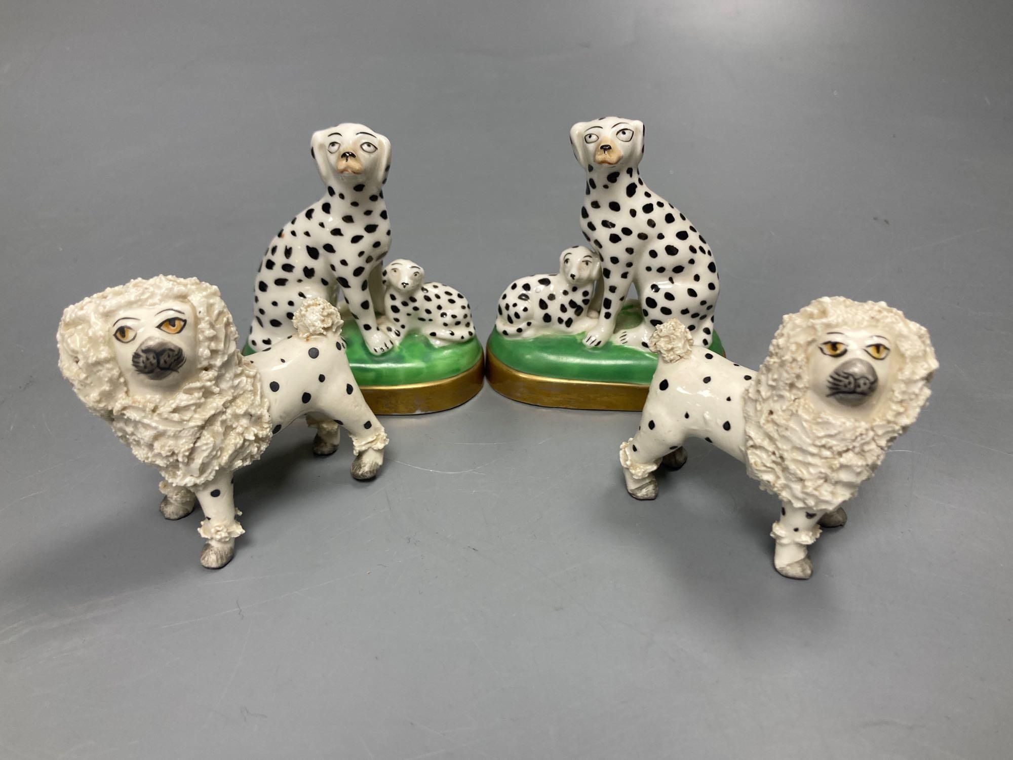 A pair of English porcelain King Charles Spaniels, 6.5cm high and a pair of Continental Dalmatians, 7.5cm high